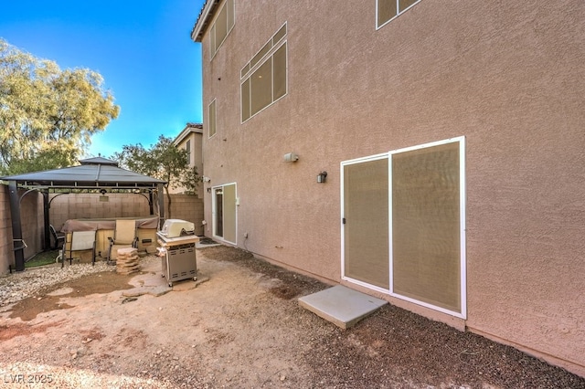 5490 Tulip Hill Ave, Las Vegas, NV 89141 - rear view of house with stucco siding, a gazebo, and a hot tub