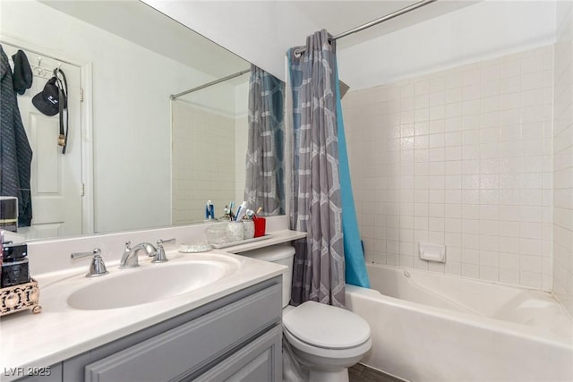 full bathroom with vanity, shower / tub combo with curtain, and toilet