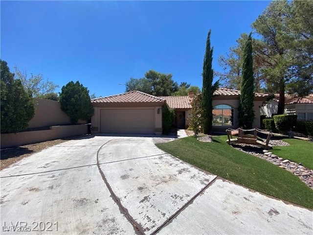 view of front of house with a garage and a front lawn