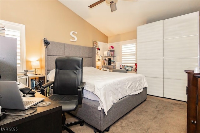 bedroom featuring lofted ceiling, carpet floors, and a ceiling fan