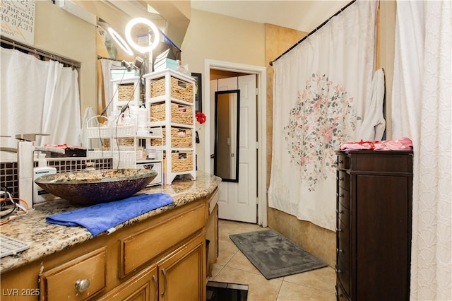 bathroom featuring tile patterned flooring, tasteful backsplash, and vanity