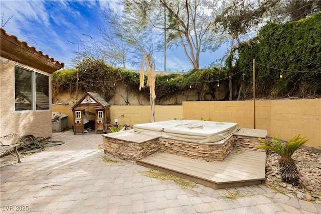 view of patio / terrace featuring a covered hot tub and a fenced backyard