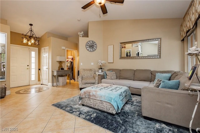 living room featuring light tile patterned floors, baseboards, high vaulted ceiling, and ceiling fan with notable chandelier