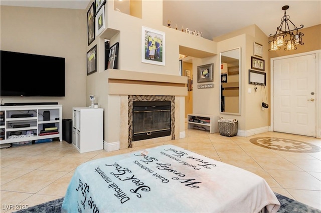 bedroom with an inviting chandelier, a fireplace, baseboards, and tile patterned floors