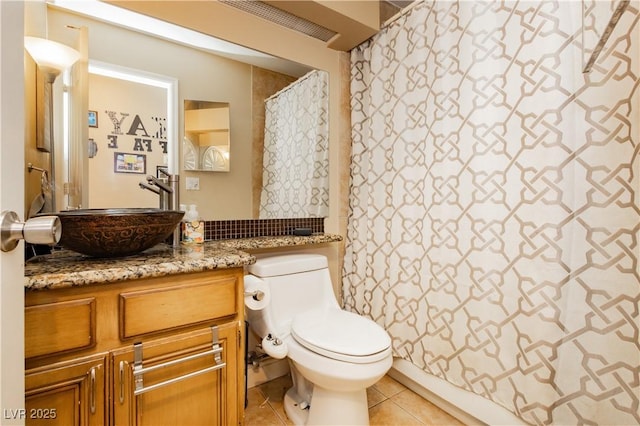 full bath with tile patterned flooring, curtained shower, vanity, and toilet