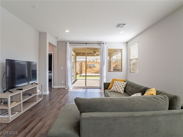 living room with plenty of natural light and dark hardwood / wood-style floors