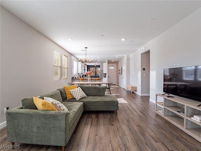 living room featuring hardwood / wood-style floors and a notable chandelier