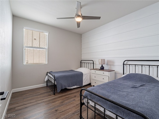 bedroom with ceiling fan and dark hardwood / wood-style floors