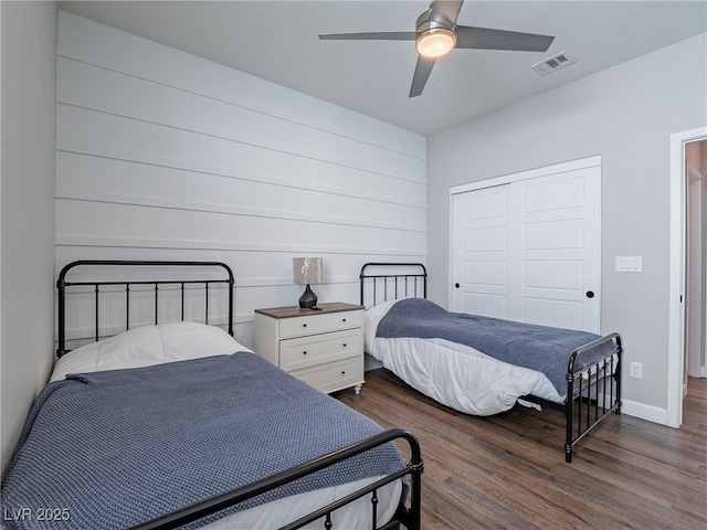 bedroom with ceiling fan, dark hardwood / wood-style flooring, and a closet