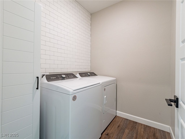 laundry area with dark wood-type flooring and washing machine and dryer