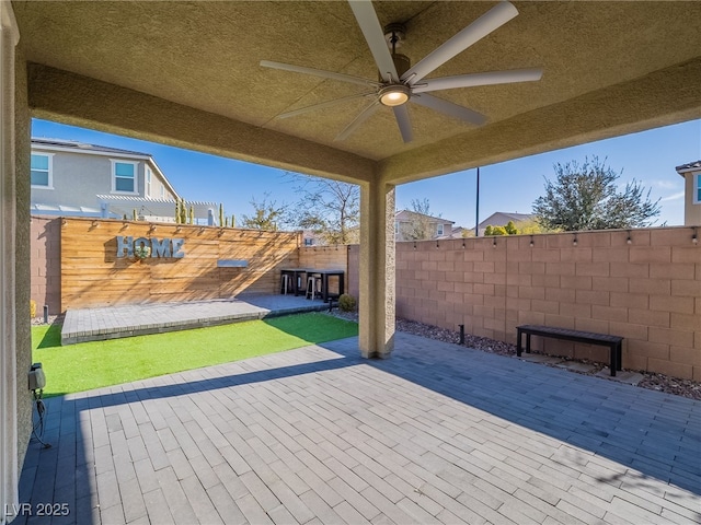 view of patio featuring ceiling fan