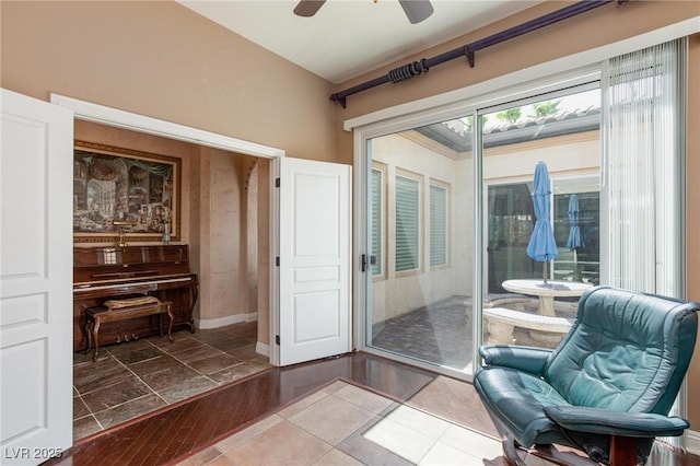 doorway with ceiling fan