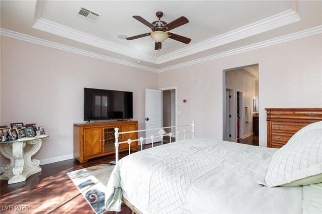 bedroom featuring a raised ceiling, crown molding, dark hardwood / wood-style floors, and ceiling fan