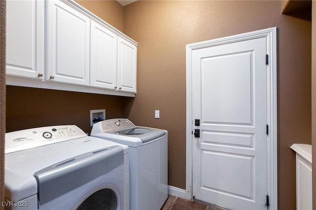 laundry area with baseboards, cabinet space, dark tile patterned flooring, and independent washer and dryer