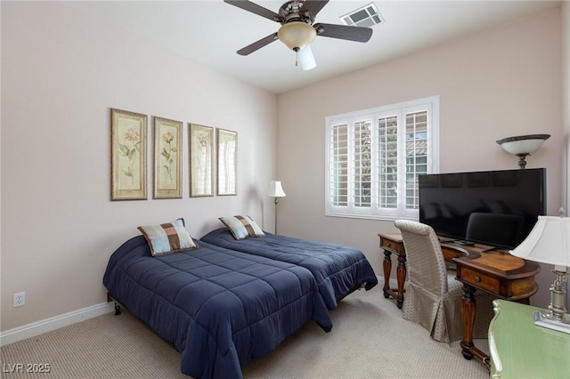 carpeted bedroom with visible vents, baseboards, and a ceiling fan