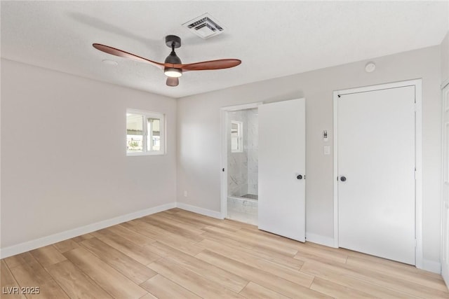 unfurnished bedroom featuring ensuite bath, light hardwood / wood-style floors, and ceiling fan