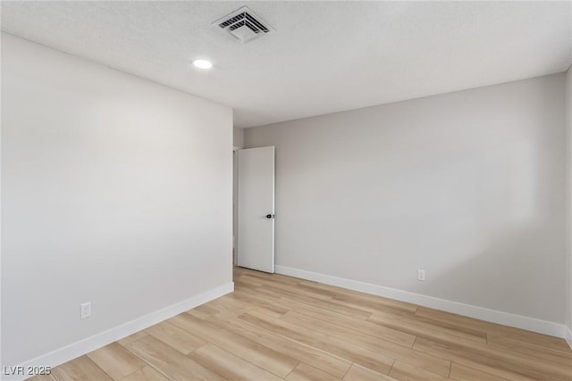 spare room with light hardwood / wood-style flooring