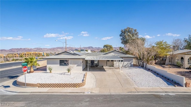 ranch-style house featuring a mountain view and solar panels