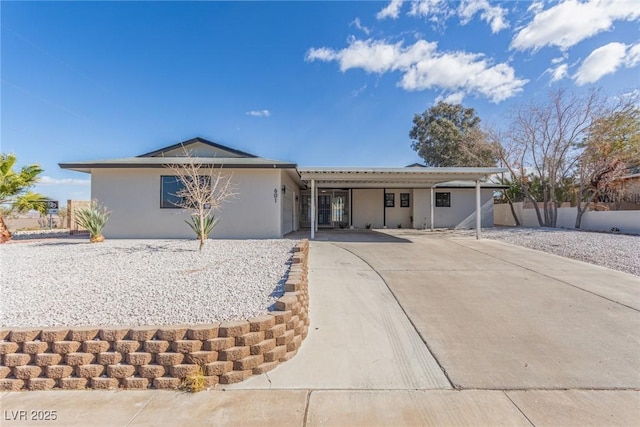 ranch-style house featuring a carport