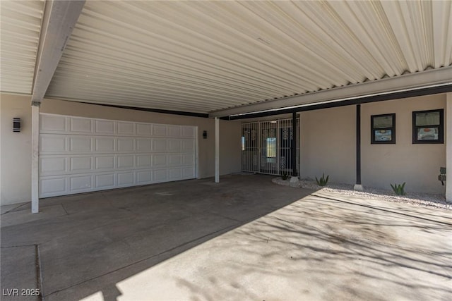 view of patio / terrace featuring a carport and a garage