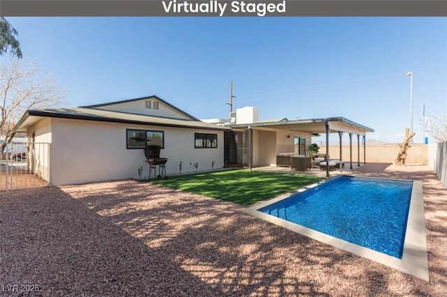 rear view of property featuring outdoor lounge area and a patio area