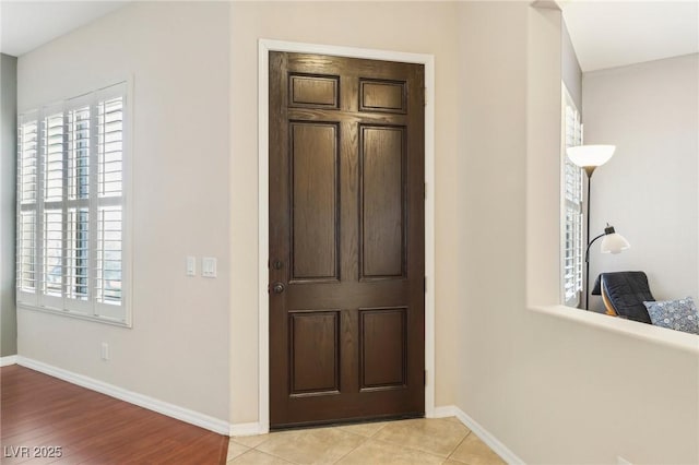 entryway with light tile patterned flooring