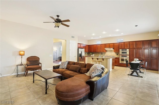 living room featuring visible vents, a ceiling fan, recessed lighting, light tile patterned flooring, and baseboards