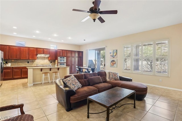 living room with light tile patterned floors, baseboards, ceiling fan, and recessed lighting