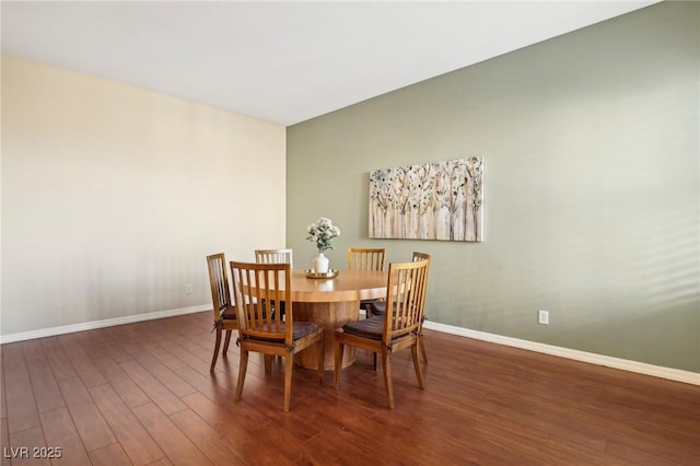 dining area with dark hardwood / wood-style flooring