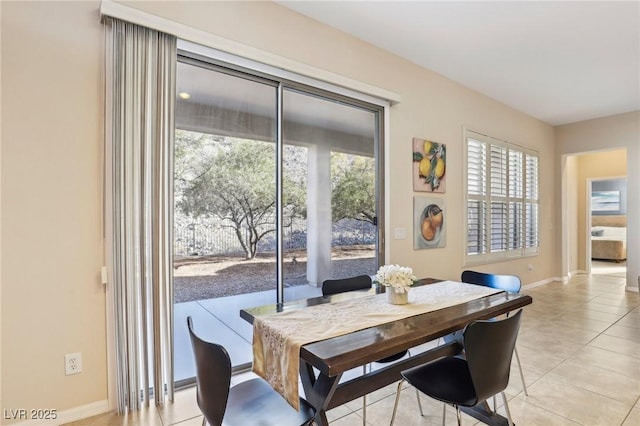 dining space with light tile patterned floors and baseboards