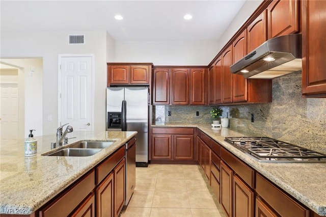 kitchen featuring light tile patterned flooring, sink, tasteful backsplash, stainless steel appliances, and light stone countertops