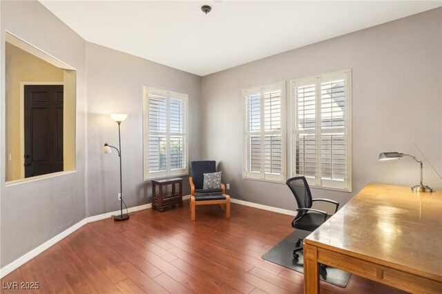 office space featuring baseboards and wood finished floors