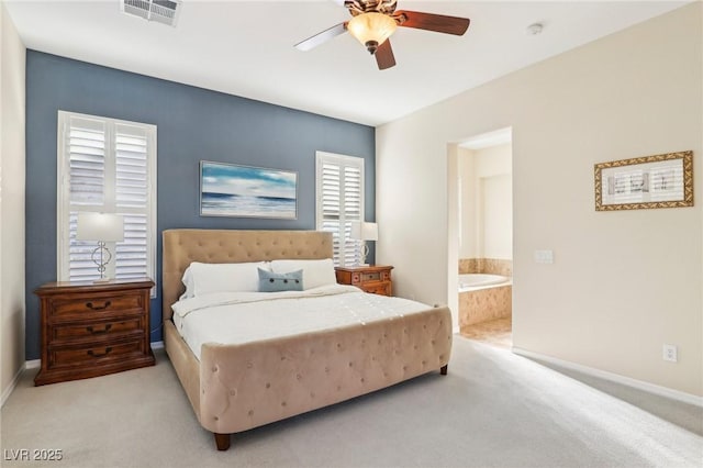 carpeted bedroom with ceiling fan, visible vents, baseboards, and connected bathroom