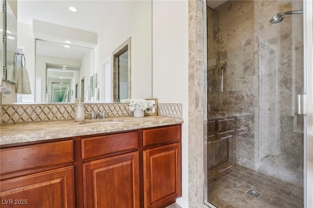 bathroom with walk in shower, vanity, and decorative backsplash