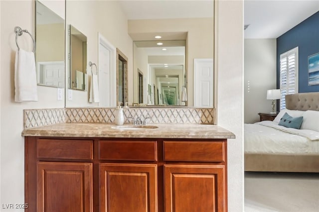 bathroom featuring vanity and backsplash