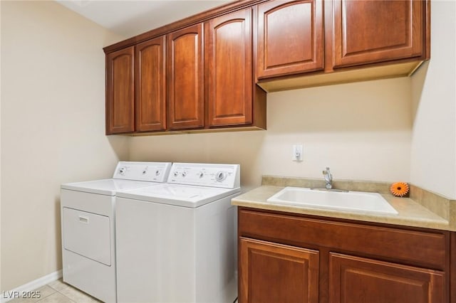 clothes washing area with cabinets, independent washer and dryer, light tile patterned flooring, and sink