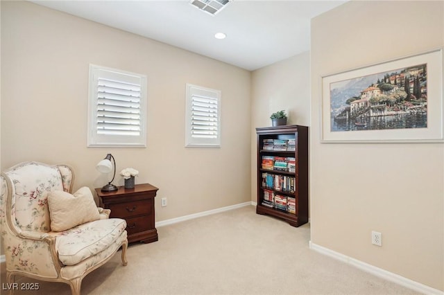 sitting room featuring light colored carpet