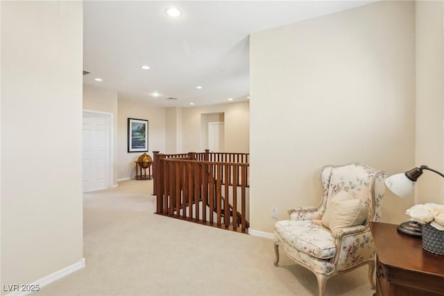 sitting room featuring light carpet