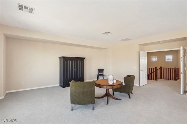 sitting room featuring light colored carpet