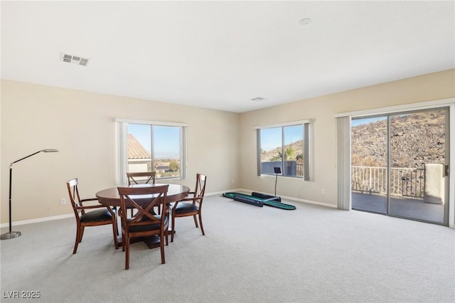 dining space with light carpet