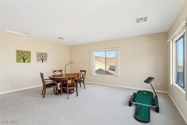 carpeted dining area with a wealth of natural light