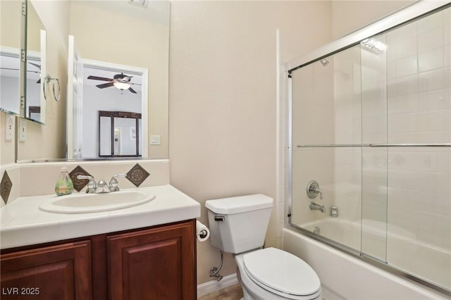 full bathroom featuring vanity, ceiling fan, enclosed tub / shower combo, and toilet