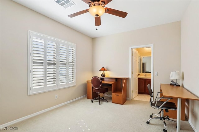 office space with light carpet, visible vents, a ceiling fan, and baseboards