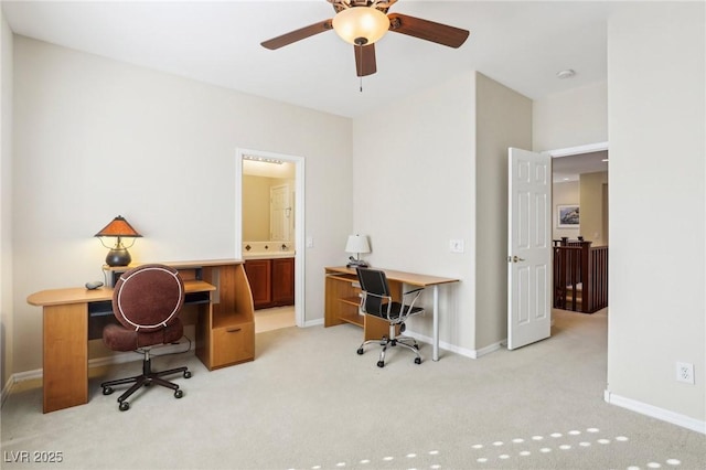 home office featuring baseboards, light colored carpet, and a ceiling fan