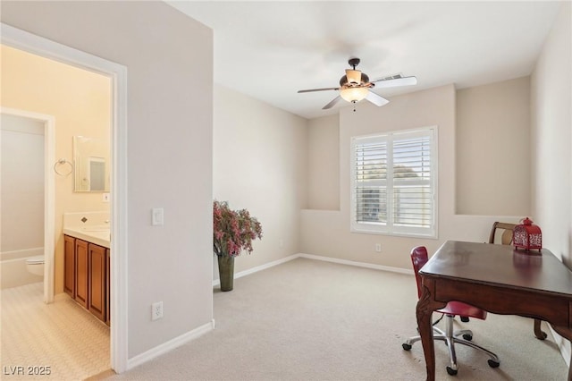 home office featuring light colored carpet, baseboards, and ceiling fan