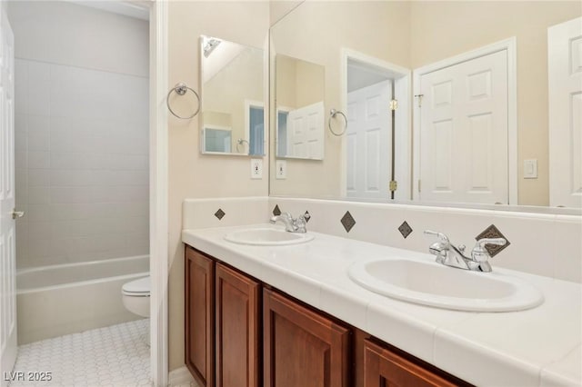 full bathroom with vanity, toilet,  shower combination, and tile patterned flooring