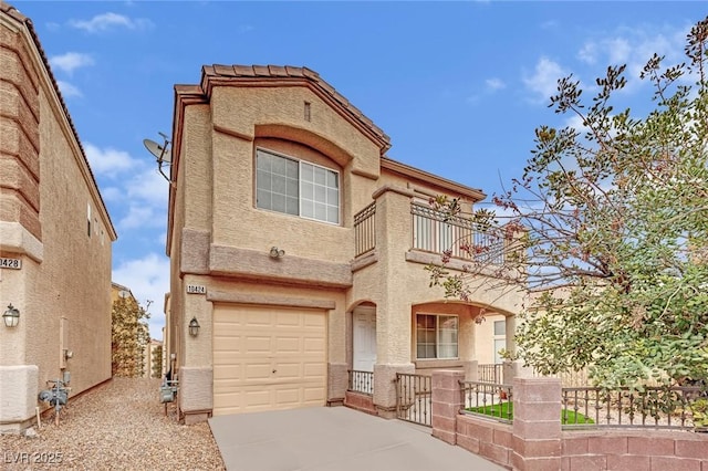 mediterranean / spanish house with a balcony, driveway, a garage, and stucco siding