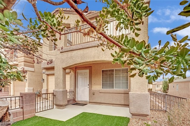 entrance to property with fence and stucco siding