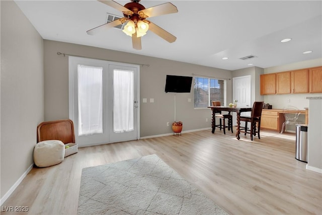 interior space with light wood finished floors, recessed lighting, visible vents, and baseboards