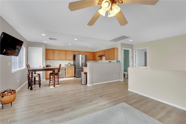 kitchen with freestanding refrigerator, visible vents, light wood finished floors, and recessed lighting